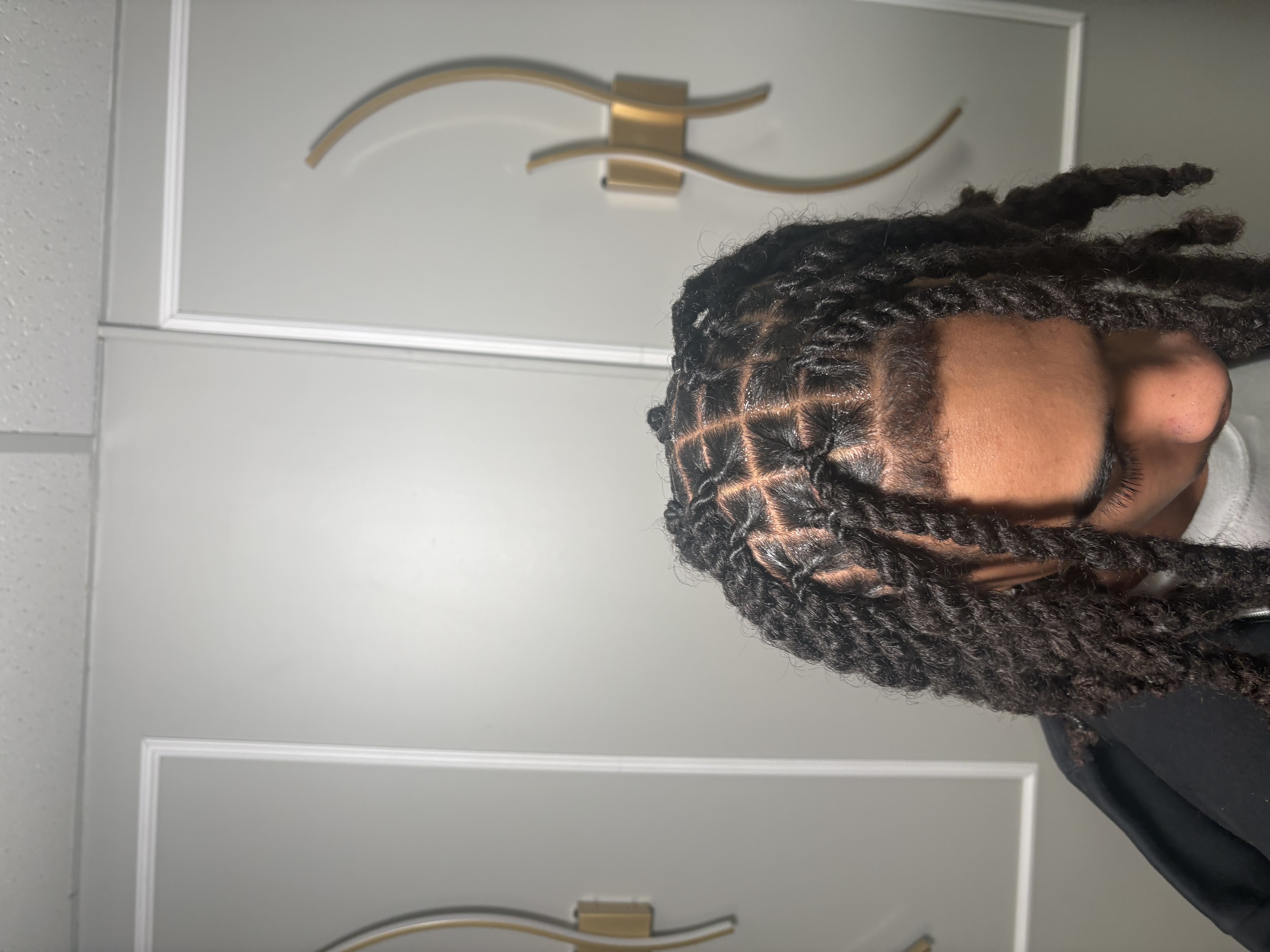 Side profile with cornrows converging at crown